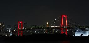 Rainbow Bridge lit up in red